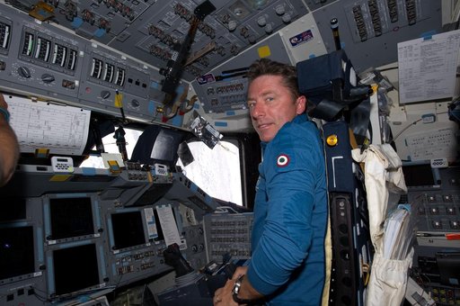 View of STS-134 MS Vittori working on the Flight Deck