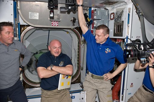 STS-134 and Expedition 27 Crew Members greet one another after Docking