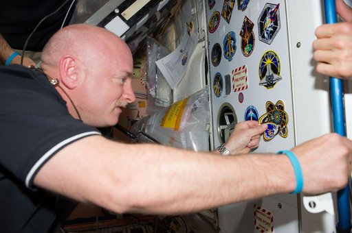 STS-134 Crew Members add Mission Sticker to Node 1 Panel