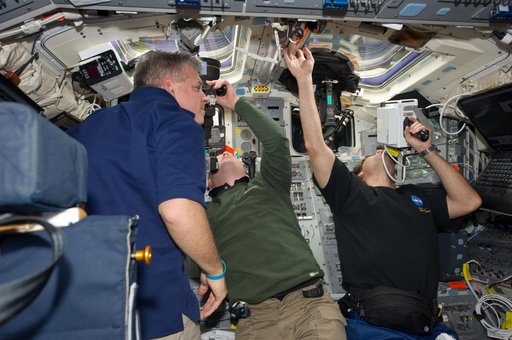 STS-134 Crew Members working on the Flight Deck
