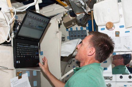 Ferguson Uses a Computer on Atlantis Middeck