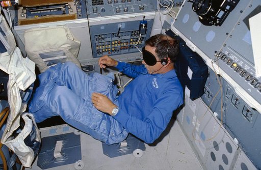 STS-26 Pilot Covey, wearing sleep mask, rests on aft flight deck