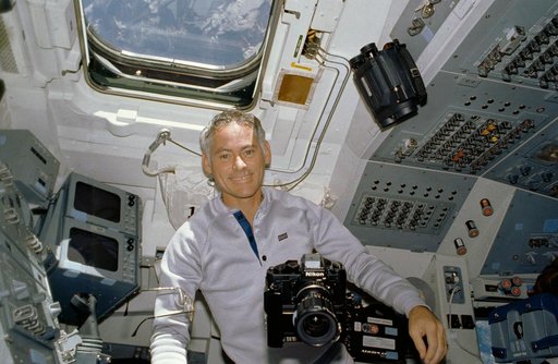 STS-27 MS Mullane on aft flight deck with camera equipment