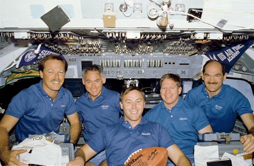 STS-27 crew poses for inflight portrait on forward flight deck with football