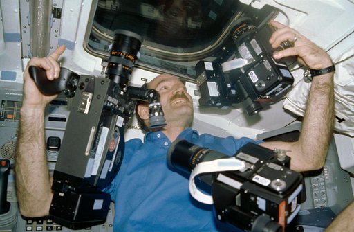 STS-27 Pilot Gardner works with cameras on aft flight deck at window W8