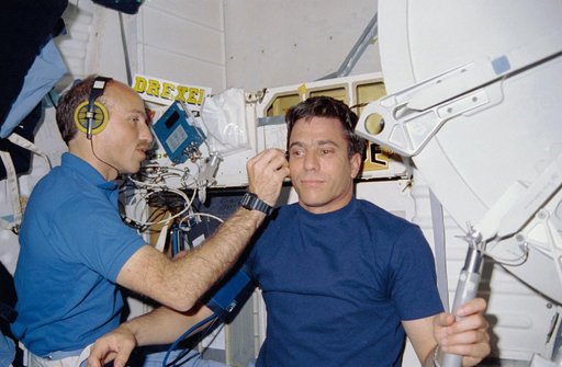 STS-29 Pilot Blaha has blood flow checked by MS Bagian on OV-103's middeck