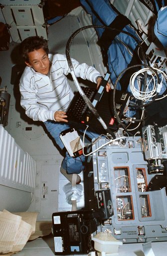STS-30 MS Cleave monitors fluids experiment apparatus (FEA) equipment
