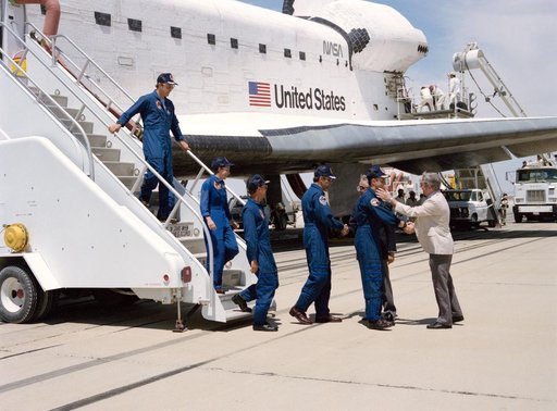 STS-30 crew egressing OV-104 is greeted by NASA administrators at EAFB