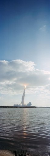 STS-31 Discovery, OV-103, is hidden in low-lying clouds after KSC liftoff