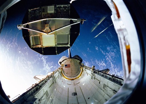 During STS-32 retrieval, RMS lowers LDEF into OV-102's payload bay (PLB)