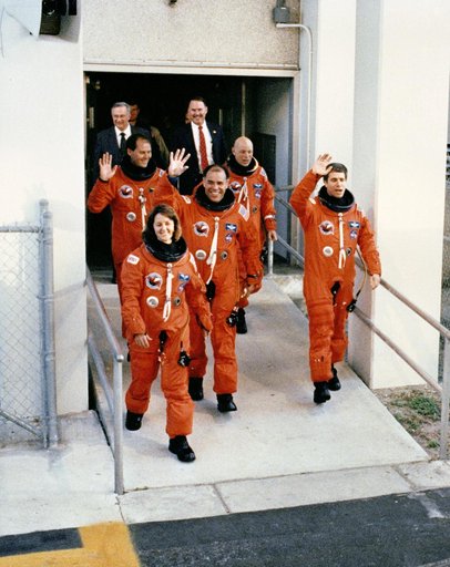 STS-33 crewmembers, wearing LESs, leave KSC O&C Bldg for launch pad