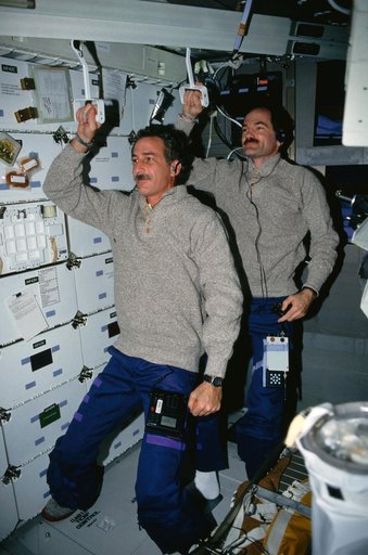 STS-35 MS Hoffman & Pilot Gardner "commute" to work on the middeck of OV-102