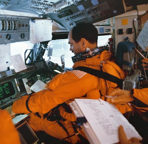 STS-35 Pilot Gardner with descent checklist on OV-102's forward flight deck