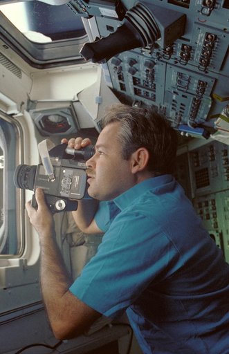 STS-36 Commander Creighton uses 70mm HASSELBLAD camera on flight deck