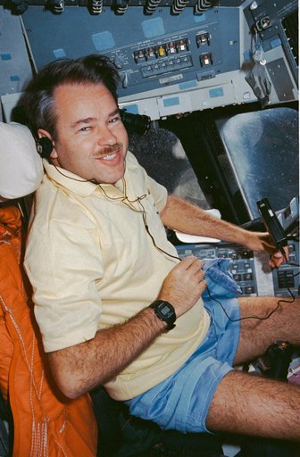 STS-36 Commander Creighton listens to music on OV-104's forward flight deck