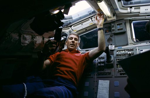 STS-38 Mission Specialist (MS) Springer uses camera on OV-104 aft flight deck