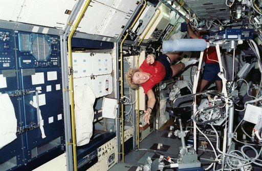 STS-40 Payload Specialist Hughes-Fulford "flies" through SLS-1 module