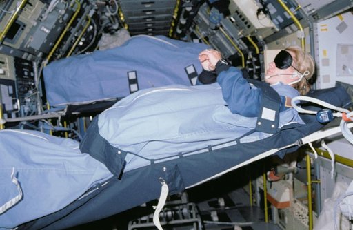 STS-40 MS Seddon, wearing blindfold, sleeps in SLS-1 module