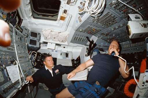 STS-41 crew communicates with ground controllers from OV-103's flight deck