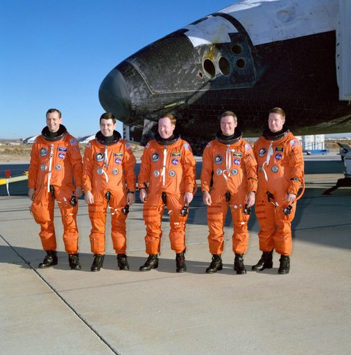 STS-41 crew poses in front of OV-103 on concrete runway 22 at EAFB, Calif