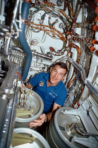 STS-44 MS Voss "Bilge Man" under OV-104's middeck subfloor repairs separator