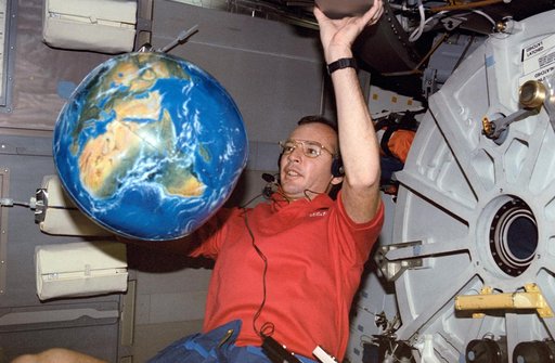 STS-45 Pilot Duffy with inflatable Earth globe on OV-104's middeck