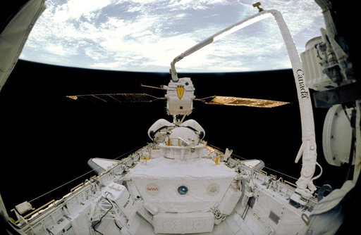 STS-46 EURECA-1L held in pre-deployment position by RMS over OV-104's PLB