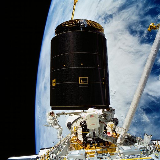 STS-49 crew captures INTELSAT VI above OV-105's payload bay (PLB) during EVA
