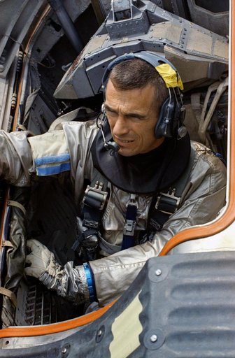 Astronaut Eugene Cernan sits in Gemini boilerplate during water egress