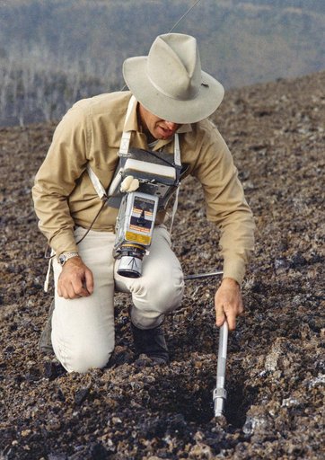 Astronauts James Lovell uses scoop from ALHT during simulation