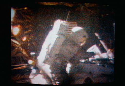 Astronaut David Scott performs the act of cancelling the first Apollo 15 commemorative postage stamp