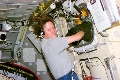 Astronaut Kathy Thornton works at Spacelab glovebox