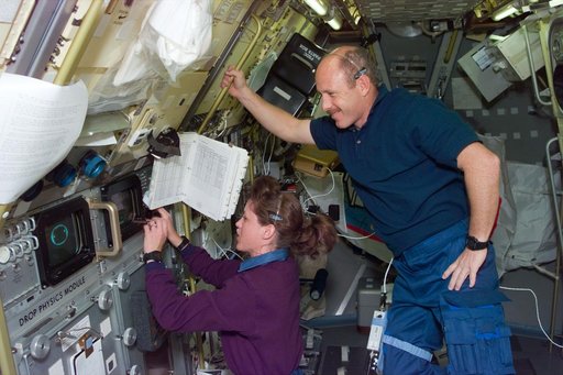 DPM, Payload Commander Kathy Thornton works with experiment as Bowersox watches
