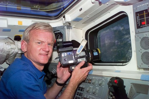Casper points camera out of aft flight deck window