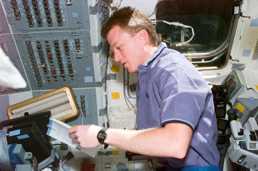 Pilot Jett reviews checklist on flight deck