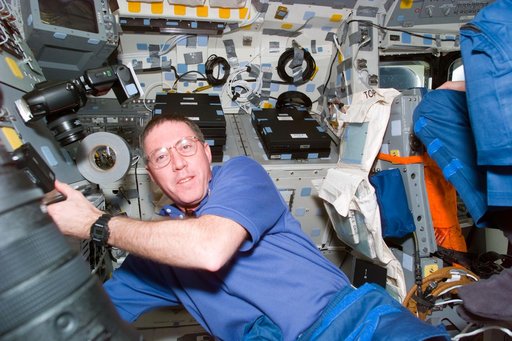Candid views of STS-81 commander and pilot on flight deck