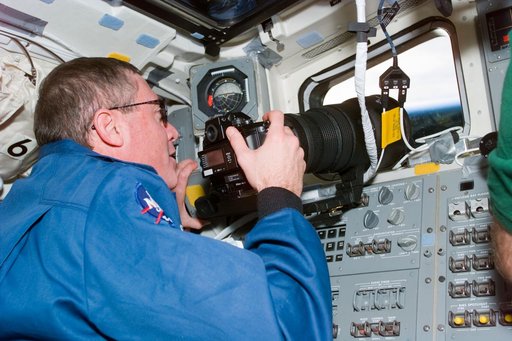 STS-81 commander Baker at aft flight deck window with camera