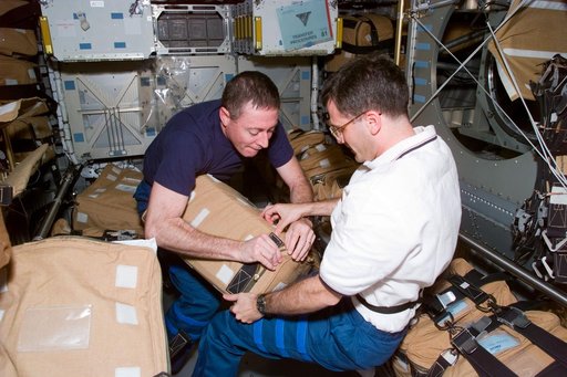 STS-81 crew packs hardware for stowage in the Spacehab