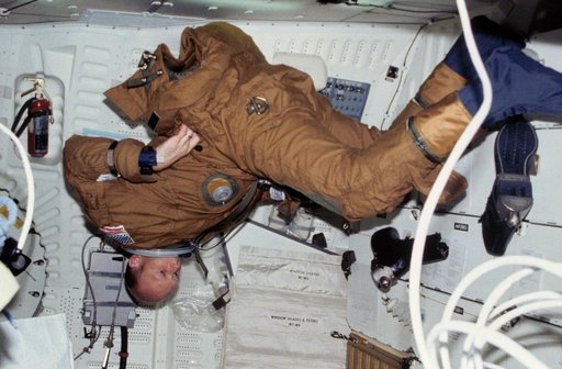 Pilot Fullerton dons anti-g and ejection escape suit (EES) on middeck