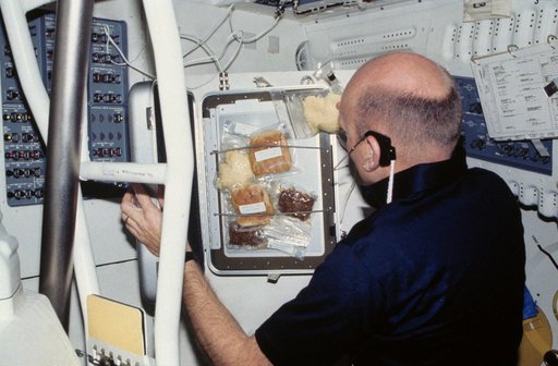 Pilot Fullerton prepares meal on middeck