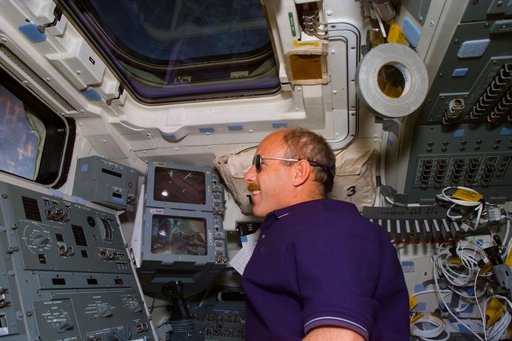 Commander Kenneth D. Bowersox looks out the aft flight deck window