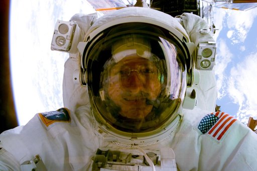 Astronaut Joe Tanner comes up close to the aft flight deck window for a photo