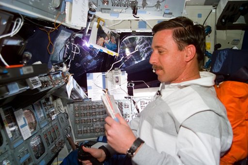 Pilot Scott Horowitz consults a checklist during a Vernier burn
