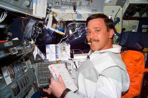 Pilot Scott Horowitz consults a checklist during a Vernier burn