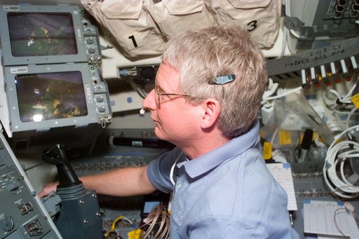 Hawley controls the RMS arm from the flight deck during EVA on Flight Day 6