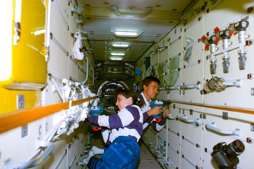 Currie and Krikalev remove launch restraint bolts in FGB/Zarya module