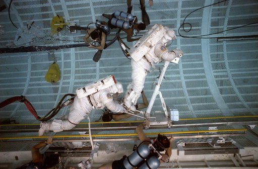 STS-37 crewmembers work with CETA during EVA training in JSC's WETF