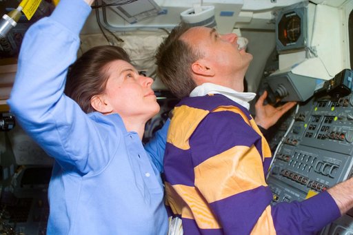 STS-89 crewmembers examine the Mir from overhead flight deck windows