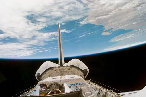 Endeavour's payload bay and tail assembly under the Earth limb