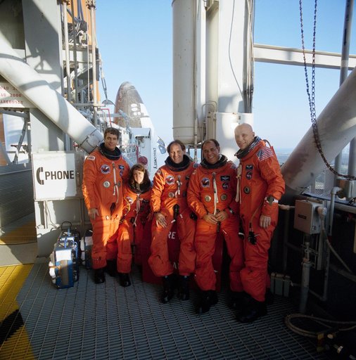STS-33 crewmembers on KSC LC Pad 39B 195 ft level with OV-103 in background